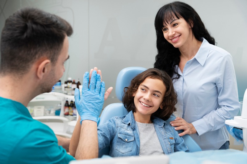 Dentist with a dental patient in the treatment room